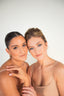 Two women pose for THE AESTHETIC CODE with rejuvenated skin.